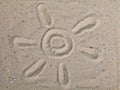 Drawing sun on sand