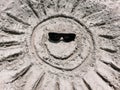Drawing of a sun with sunglasses in the sand. Summertime, fun, sea and vacation