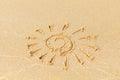 Drawing on a sunny beach. The sun is drawn by hand on the sand, washed away by the sea wave. Vacation concept on a sandy Royalty Free Stock Photo