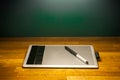 Drawing tablet and pen on wood desk table Royalty Free Stock Photo