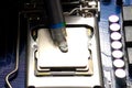 Drawing thermal paste on computer processor. Installing a cooling system on a CPU processor Royalty Free Stock Photo