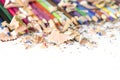 Drawing tools background. Lot of colorful pencils frame with sawdust and shavings Royalty Free Stock Photo