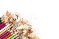 Drawing tools background. Lot of colorful pencils frame with sawdust and shavings on white Royalty Free Stock Photo