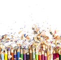 Drawing tools background. Lot of colorful pencils frame with sawdust and shavings on white Royalty Free Stock Photo