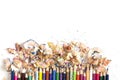 Drawing tools background. Lot of colorful pencils frame with sawdust and shavings on white Royalty Free Stock Photo