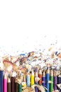 Drawing tools background. Lot of colorful pencils frame with sawdust and shavings on white Royalty Free Stock Photo