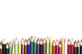 Drawing tools background. Lot of colorful pencils frame with sawdust and shavings on white Royalty Free Stock Photo