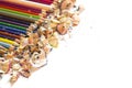 Drawing tools background. Lot of colorful pencils frame with sawdust and shavings on white Royalty Free Stock Photo