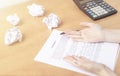 Drawing up and signing insurance contract. Close-up female hands hold pen to fill out document and consider contract value on Royalty Free Stock Photo