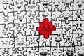 Drawing of white puzzle pieces and one red with different emotions, closeup. Bullying concept Royalty Free Stock Photo