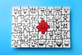 Drawing of white puzzle pieces and one red with different emotions on turquoise background, top view. Bullying concept Royalty Free Stock Photo