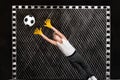 Boy goalkeeper catches a football.Drawings in chalk on the wall.