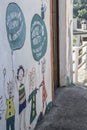 drawings on the facade of a school of smiling children with balloons