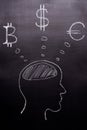 Drawn with chalk on a black background - the man`s head with thoughts of world currencies, Bitcoin, Dollar, Euro. The concept of