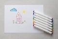 Drawn by colorful felt-tip pens a child`s drawing on a white sheet of paper - a house, flowers, the sun and cloud. Creativity, Royalty Free Stock Photo