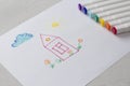 Drawn by colorful felt-tip pens a child`s drawing on a white sheet of paper - a house, flowers, the sun and cloud. Creativity, Royalty Free Stock Photo