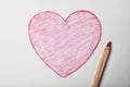 Drawn heart and pencil on sheet of paper Royalty Free Stock Photo