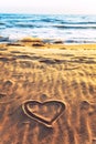 Drawn heart shape on sea sand beach Royalty Free Stock Photo