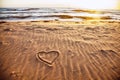 Drawn heart shape on sea sand beach. Royalty Free Stock Photo