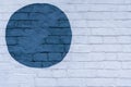 Drawn painted blue circle on a light brick wall bricks surface of wall, as graffiti. Graphic abstract modern background Royalty Free Stock Photo