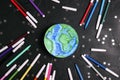 Drawn planet Earth with multicolored felt-tip pens on on a black background wih stars. Education, science, ecology, environmental