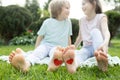 drawn red hearts on the bare feet of two happy children sitting on the grass Royalty Free Stock Photo