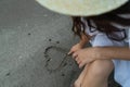 Draws a heart on the sand