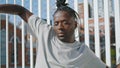 Dreadlocks guy moving body at street closeup. African american man dancing hands