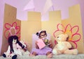 Dream big baby girl. an adorable little girl reading a book surrounded by her toys. Royalty Free Stock Photo