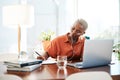 Dream big and do bigger. Shot of a young businesswoman wearing earphones while writing notes in an office. Royalty Free Stock Photo