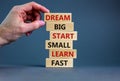 Dream big start small symbol. Words `dream big start small learn fast` on wooden blocks on a beautiful grey background. Royalty Free Stock Photo