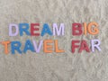 Dream big travel far written on sand at the beach Royalty Free Stock Photo