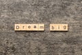 Dream big word written on wood block. Dream big text on cement table for your desing, Top view concept Royalty Free Stock Photo