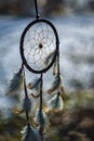 The Dream catcher with feathers threads and beads rope hanging and nice bokeh background - art picture with depht of focus Royalty Free Stock Photo