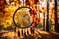 A dream catcher framed by the vibrant hues of autumn leaves, with a soft breeze causing the feathers to sway gently in the forest