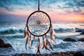 A dream catcher gently swaying in a coastal breeze, against a backdrop of crashing waves and a pastel-colored sky during twilight