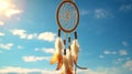 Dream catcher on hand with blue sky background. It is swing by wind.It is made from the feather, bead,leather and rope.The amulet Royalty Free Stock Photo