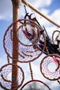 Dream catcher with red threads, beads and feathers of white, pink and black Royalty Free Stock Photo