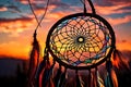 A dream catcher silhouetted against a vivid, multicolored sunset sky, showcasing its intricate design and vibrant feathers