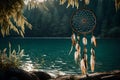 A dream catcher swaying gently by a lakeside, with its feathers softly brushing against the rippling water, creating a serene Royalty Free Stock Photo