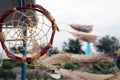 Dream catchers develop in the wind against the backdrop of the beach. A lot of space in the frame creates a feeling of calm and