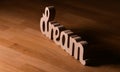 Dream concept. Wood letters spelling the word dream placed on a wooden table Royalty Free Stock Photo