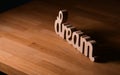 Dream concept. Wood letters spelling the word dream placed on a wooden table Royalty Free Stock Photo