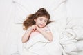 A girl of 4 years sleeping in white bed