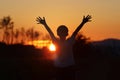 Child with arms outstretched towards the sun dreams and hopes, challenge and success concept