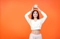 Dream of a house. Own home concept. Cheerful woman holding a little toy house above her head. Royalty Free Stock Photo