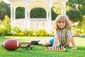 Dream kids and childhood concept. Early development. Boy thinking about chess in summer park. The concept of learning Royalty Free Stock Photo