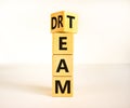 Dream team dreamteam symbol. Turned a wooden cube and changed the word Dream to Team. Beautiful white table white background.