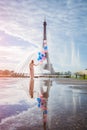 Dream travel - young woman with balloons walking near Eiffel Tower in Paris