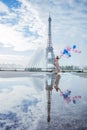 Dream travel - young woman with balloons walking near Eiffel Tower in Paris Royalty Free Stock Photo